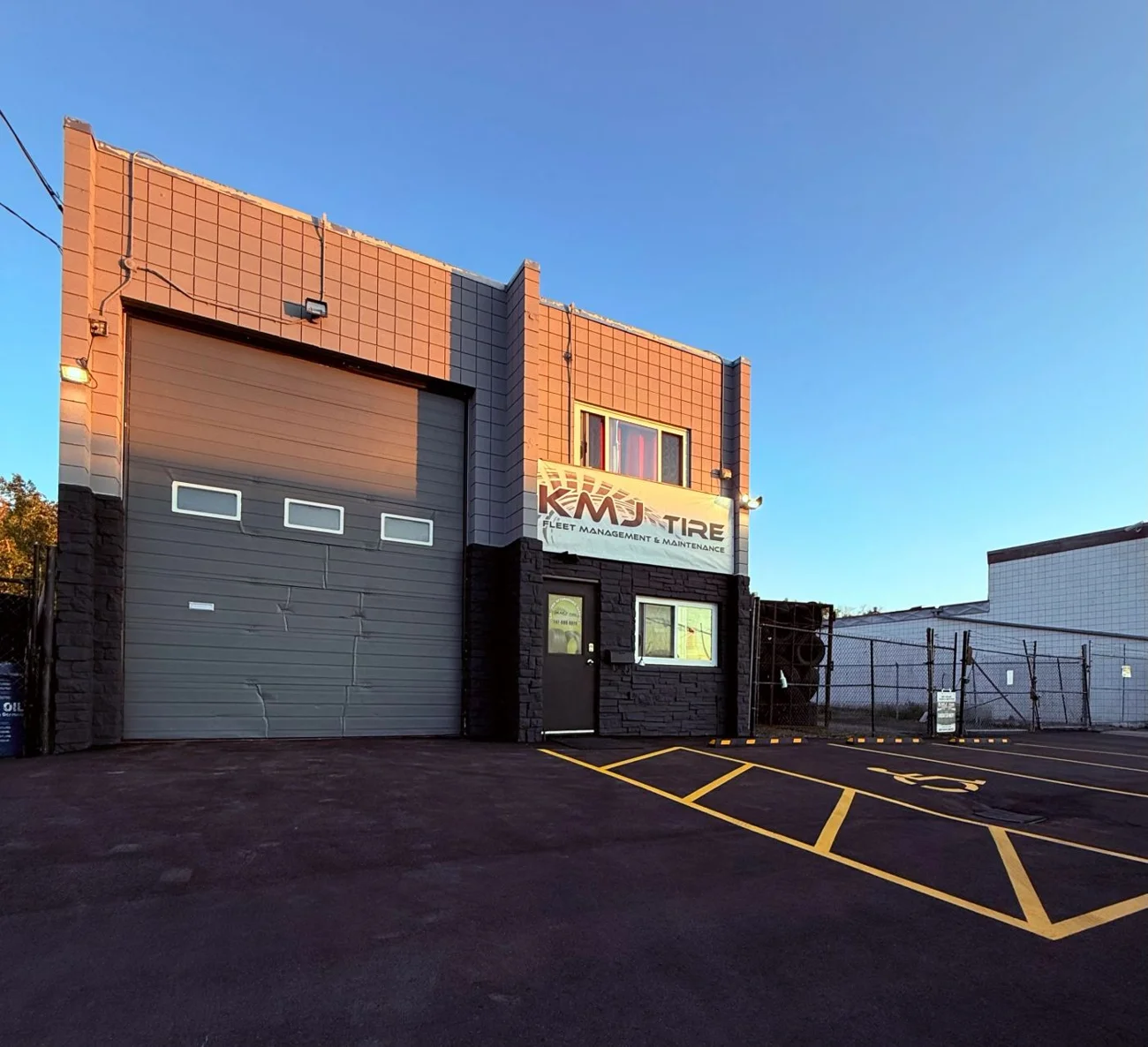 KMJ Tire’s storefront and customer entrance at 911 48 Avenue SE